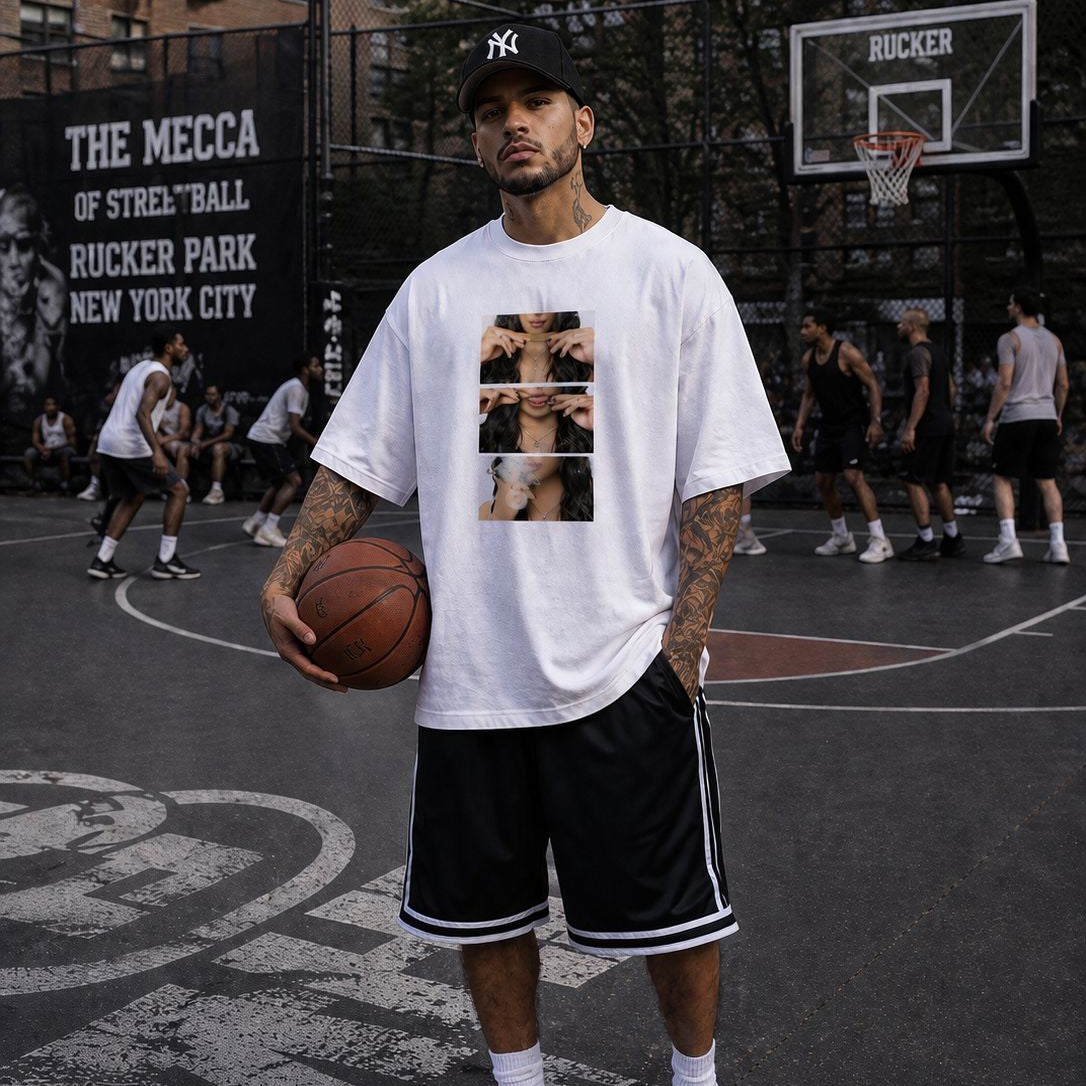 Man holding a basketball on a basketball court with 'Rucker Park' in the background